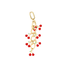 Gold bikini charm with red cherry accents, inspired by Alix Earle's viral Dorne beach jewelry look.