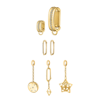 Yellow gold charms from Dorne’s Golden Girl Set styled on a black bikini top, reflecting summer boho elegance.